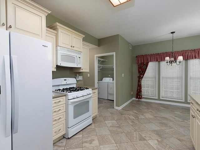 kitchen featuring white appliances, separate washer and dryer, cream cabinets, an inviting chandelier, and pendant lighting