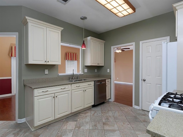 kitchen featuring white appliances, white cabinetry, a sink, baseboards, and pendant lighting