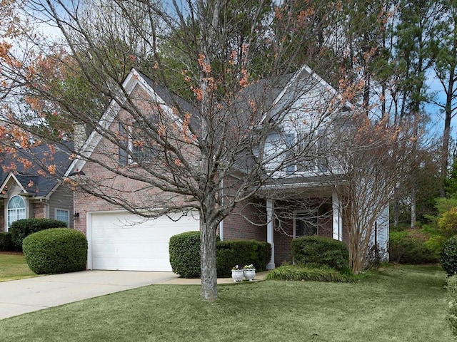 view of property hidden behind natural elements with concrete driveway, a front yard, and brick siding