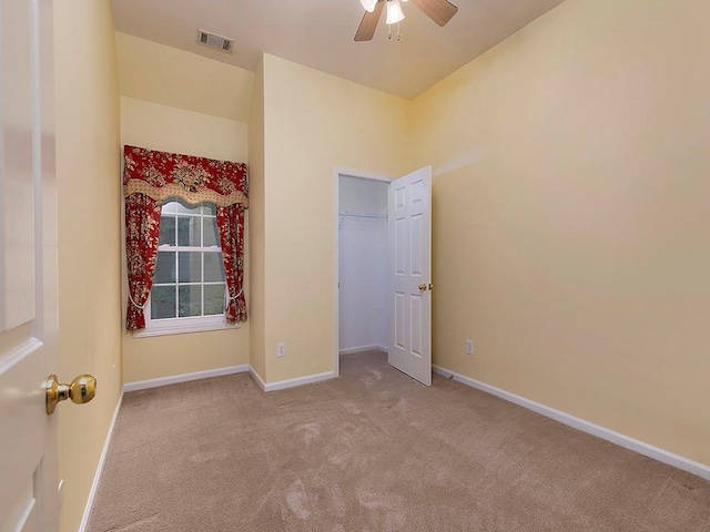 unfurnished bedroom with carpet flooring, visible vents, and baseboards