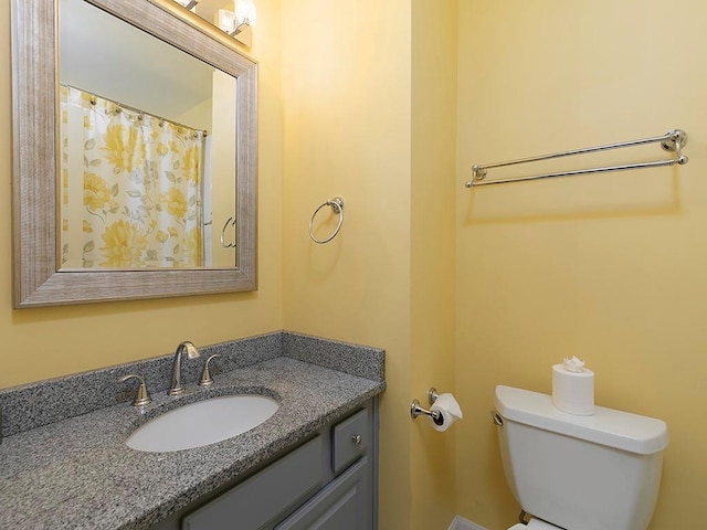 bathroom featuring toilet and vanity
