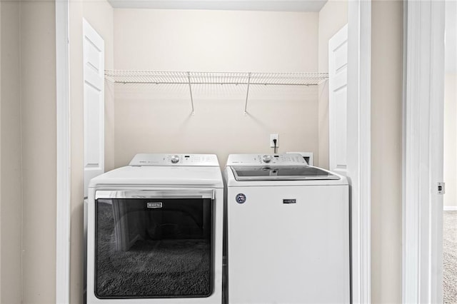 laundry area with washer and clothes dryer and carpet