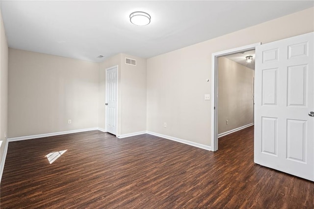 unfurnished room featuring dark wood-type flooring