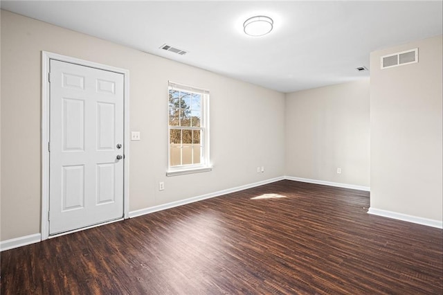 spare room with dark wood-type flooring