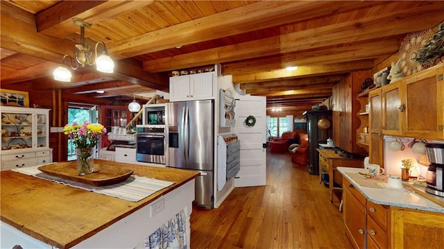 kitchen with open shelves, appliances with stainless steel finishes, dark wood-type flooring, wood ceiling, and beamed ceiling