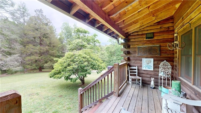 wooden terrace featuring a lawn