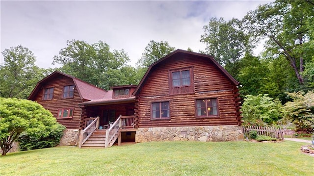 back of house with a lawn, log siding, and a gambrel roof