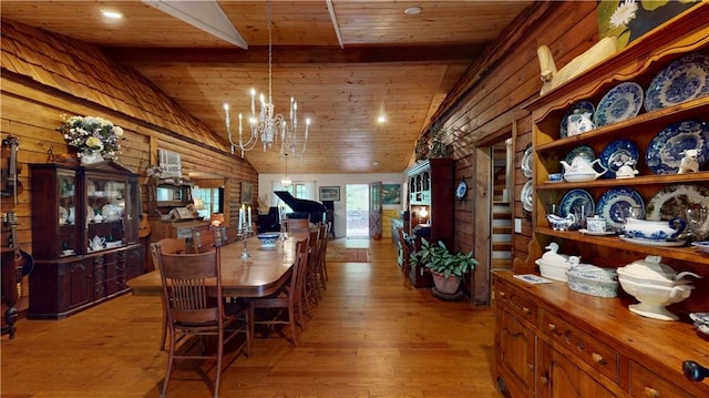 dining area with wooden ceiling, a chandelier, vaulted ceiling, and light wood-style floors