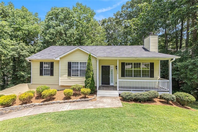 7420 Bristol Cir, Douglasville, GA 30134 - view of front of house featuring covered porch, a chimney, and a front yard