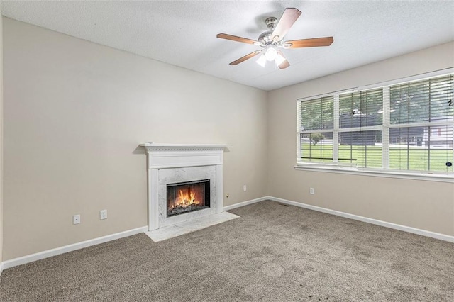 7420 Bristol Cir, Douglasville, GA 30134 - unfurnished living room featuring carpet, a premium fireplace, ceiling fan, and a textured ceiling