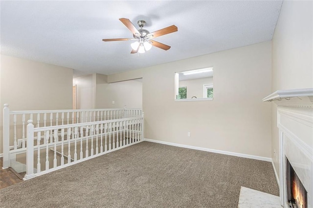 7420 Bristol Cir, Douglasville, GA 30134 - carpeted spare room featuring ceiling fan, a fireplace with flush hearth, and a textured ceiling