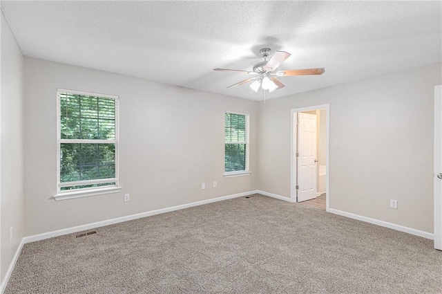 7420 Bristol Cir, Douglasville, GA 30134 - spare room with plenty of natural light, carpet flooring, ceiling fan, and a textured ceiling