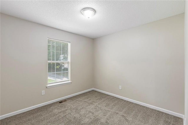 7420 Bristol Cir, Douglasville, GA 30134 - carpeted spare room with a textured ceiling and baseboards