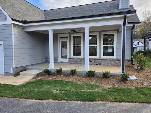 doorway to property with ceiling fan and a porch