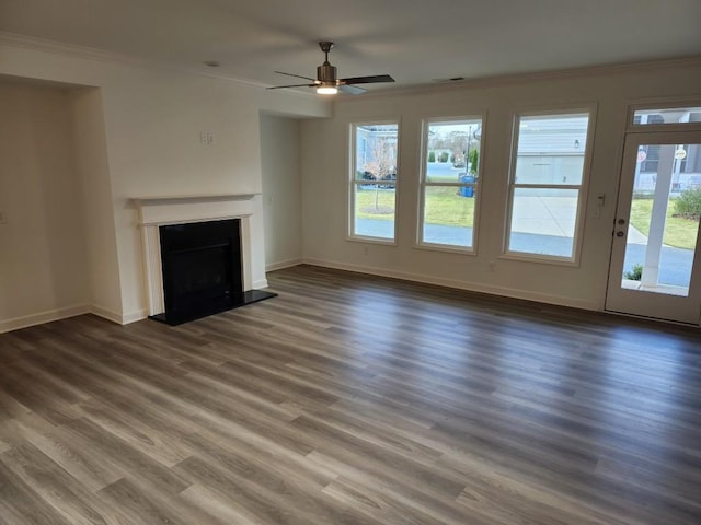 unfurnished living room with ornamental molding, ceiling fan, and dark wood-type flooring