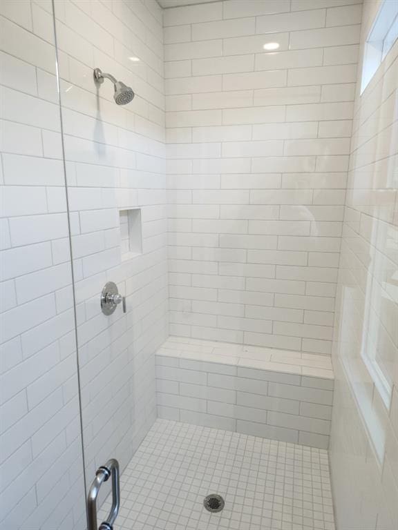 bathroom with a shower with door