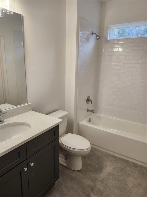 full bathroom featuring tile patterned flooring, vanity, toilet, and tiled shower / bath