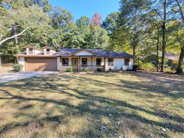 single story home with covered porch, a front yard, and a garage