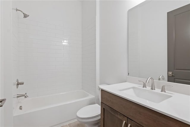 bathroom featuring washtub / shower combination, vanity, and toilet