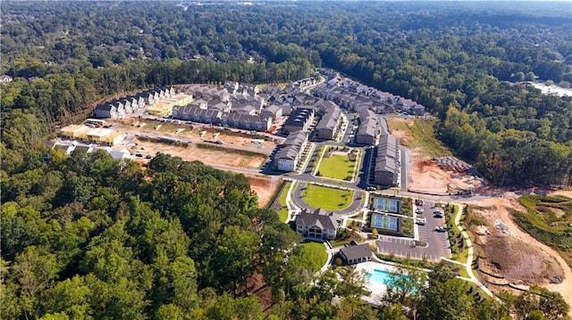 drone / aerial view featuring a wooded view