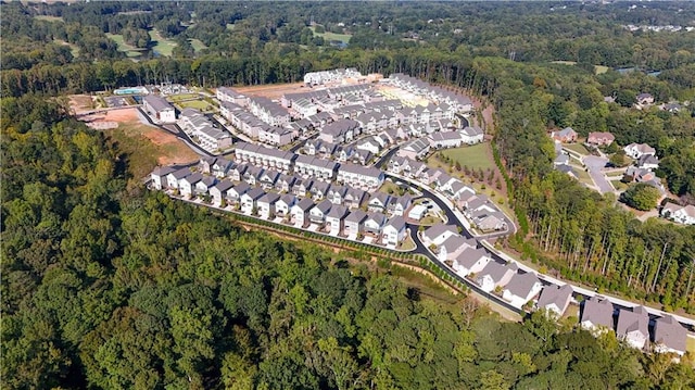 birds eye view of property with a residential view and a wooded view