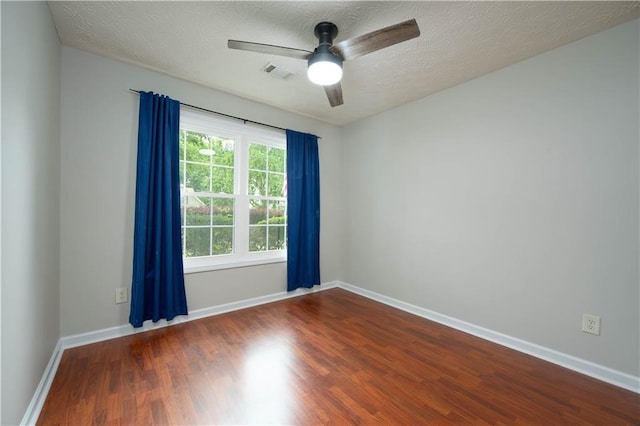 5279 Leecroft Dr, Buford, GA 30518 - spare room with dark wood-style floors, a ceiling fan, and a textured ceiling