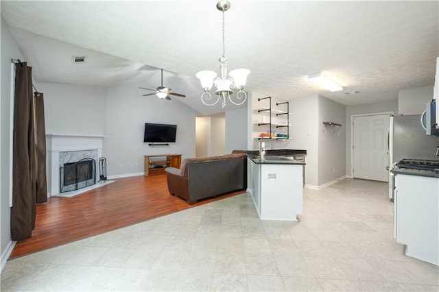 5279 Leecroft Dr, Buford, GA 30518 - kitchen featuring dark countertops, open floor plan, a chandelier, stainless steel microwave, and ceiling fan