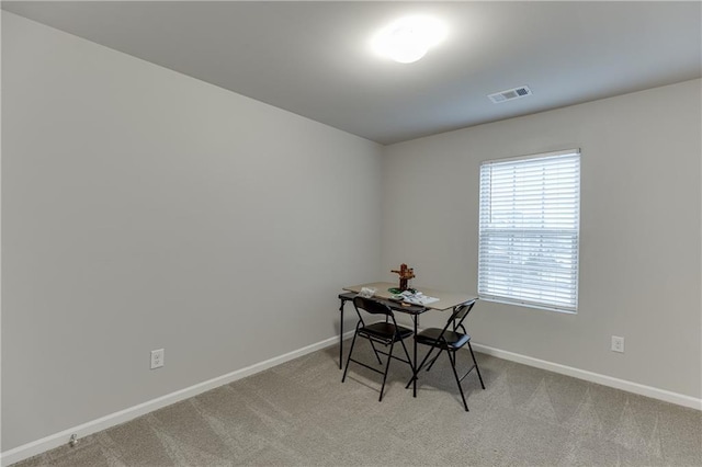 dining room featuring light carpet