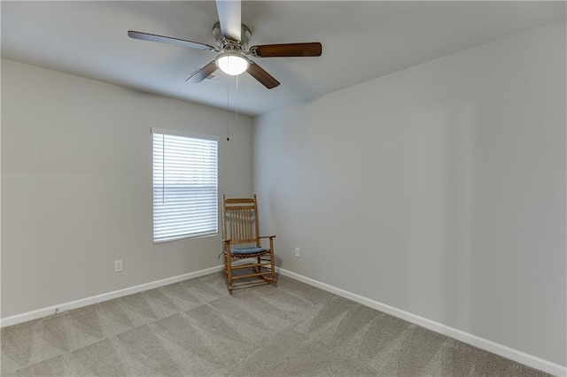 unfurnished room with light colored carpet and ceiling fan