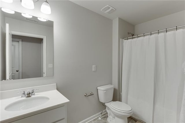 bathroom with vanity, toilet, and walk in shower