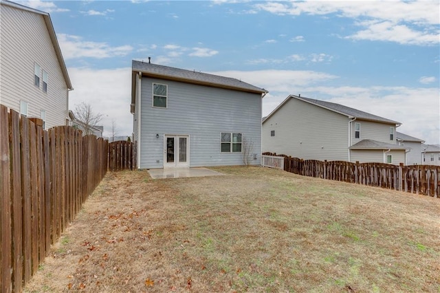 back of house with a yard, a patio area, and french doors