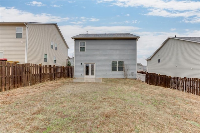 back of property featuring a lawn and a patio area