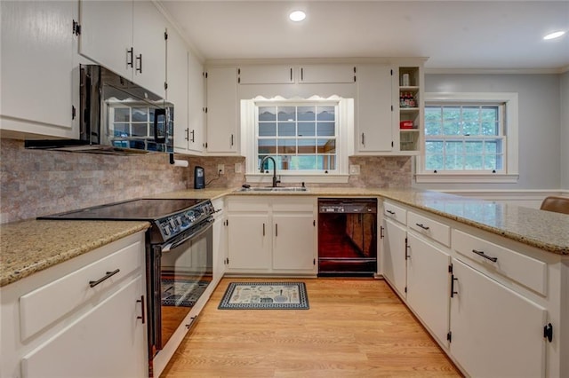 500 Cochran Rd, Covington, GA 30014 - kitchen featuring black appliances, a sink, light wood-style flooring, backsplash, and recessed lighting