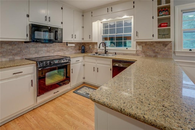 500 Cochran Rd, Covington, GA 30014 - kitchen with black appliances, a sink, decorative backsplash, light wood-style flooring, and white cabinetry