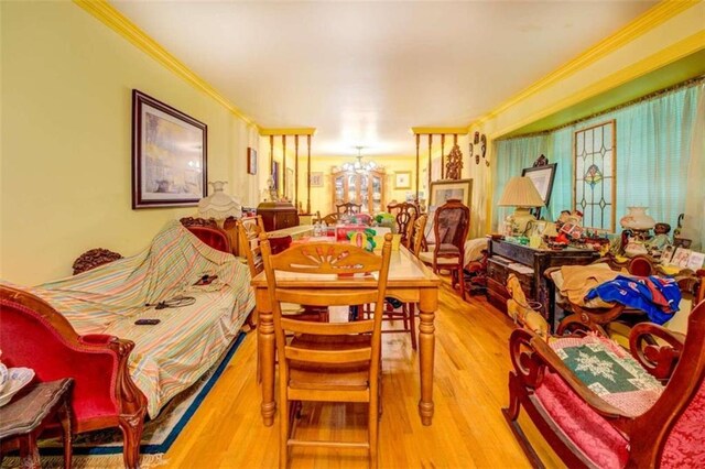 bedroom with a notable chandelier, ornamental molding, and hardwood / wood-style floors