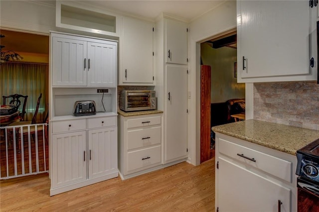500 Cochran Rd, Covington, GA 30014 - kitchen with backsplash, light wood-style flooring, white cabinets, and ornamental molding