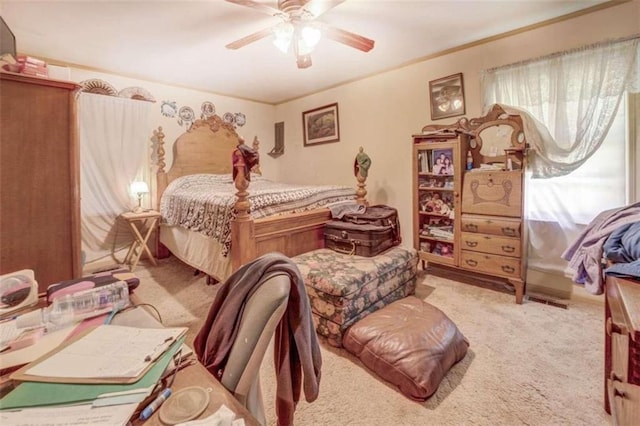 bedroom featuring a ceiling fan and light colored carpet