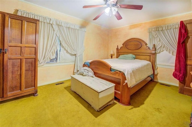 bedroom with light colored carpet, visible vents, ceiling fan, and baseboards