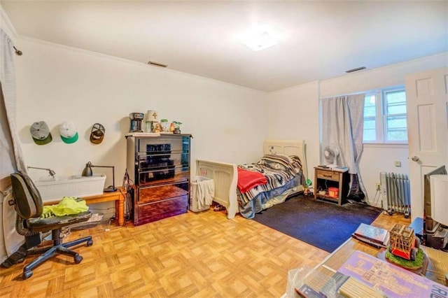 bedroom featuring visible vents and radiator heating unit