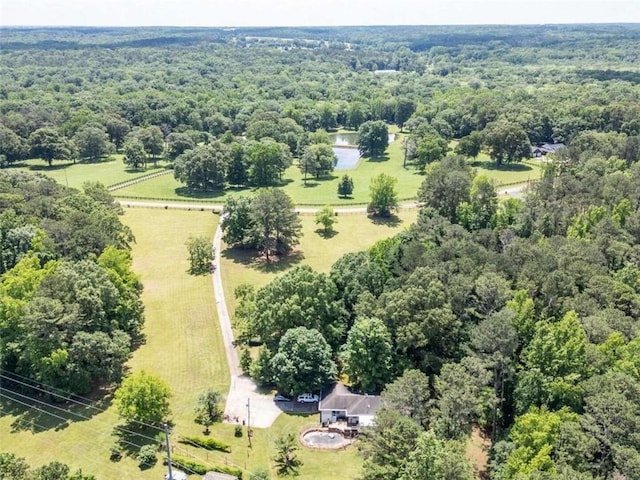 birds eye view of property with a view of trees and a rural view