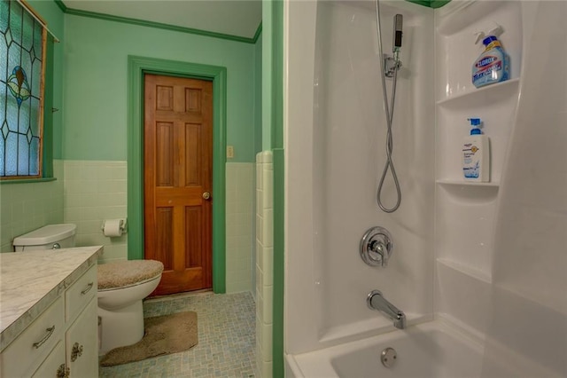 500 Cochran Rd, Covington, GA 30014 - bathroom featuring tile walls, a wainscoted wall, vanity, shower / washtub combination, and tile patterned flooring