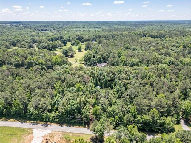 birds eye view of property featuring a wooded view