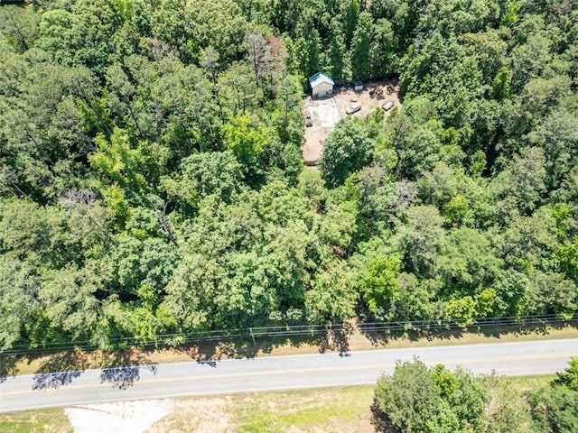 birds eye view of property featuring a wooded view