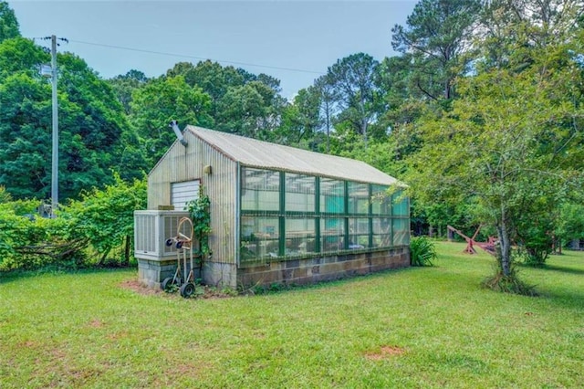 view of greenhouse with a lawn