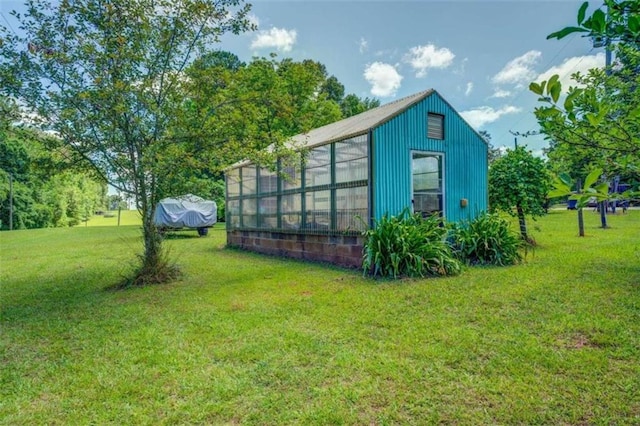 view of outdoor structure with a lawn