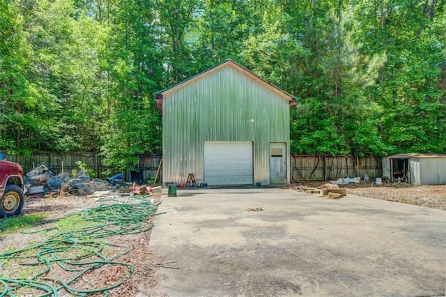 detached garage featuring fence