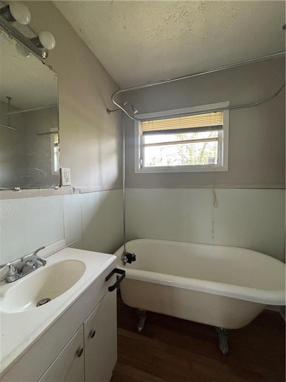 2069 Bixler Cir, Decatur, GA 30032 - bathroom with vanity, tub / shower combination, a textured ceiling, and wood finished floors