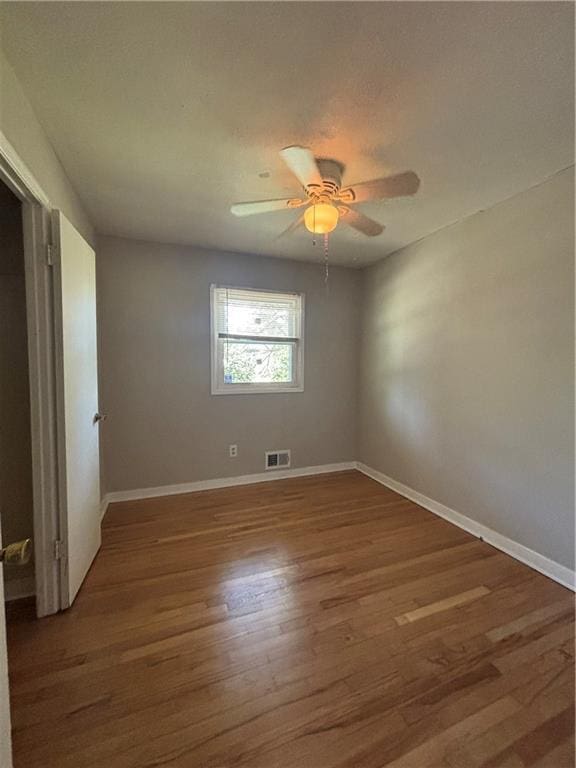 2069 Bixler Cir, Decatur, GA 30032 - empty room featuring visible vents, a ceiling fan, baseboards, and wood finished floors