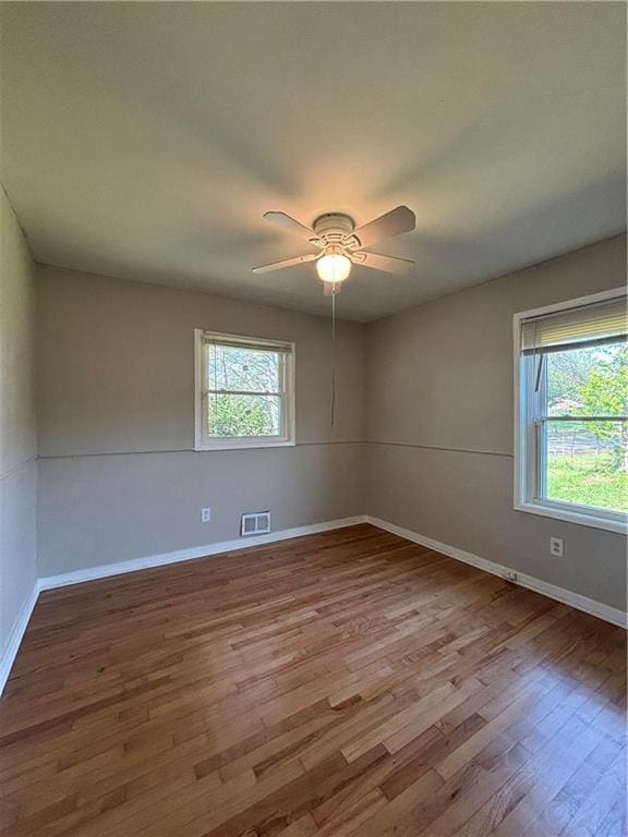 2069 Bixler Cir, Decatur, GA 30032 - empty room featuring a healthy amount of sunlight, baseboards, wood finished floors, and visible vents