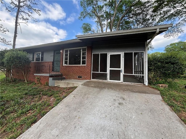 2069 Bixler Cir, Decatur, GA 30032 - rear view of property with brick siding and a sunroom